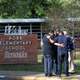 People hug outside Robb Elementary School, the scene of a mass shooting in Uvalde, Texas, U.S.